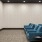 a room with blue chairs and a large screen