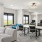 room with large windows and computers at desks