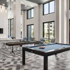 Take advantage of all Brea Luxury Apartments has to offer a room with game tables and large windows