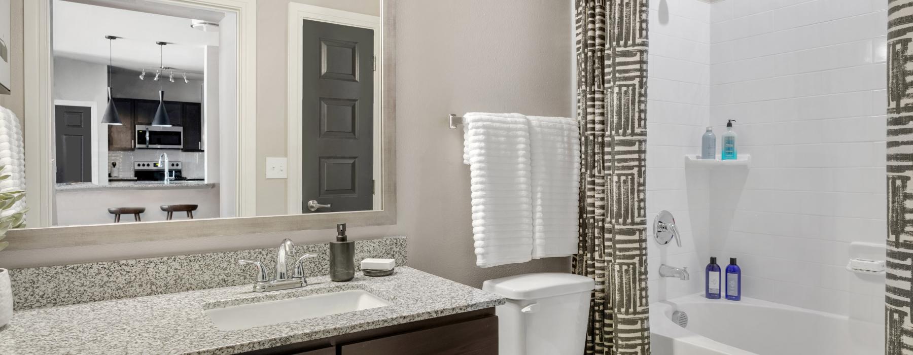 a bathroom with a tub sink and toilet